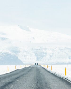 Motorcyclists on a winter road with snow in Skaftafell, Iceland