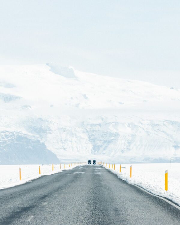 Motorcyclists on a winter road with snow in Skaftafell, Iceland