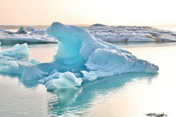 Blue iceberg in Jökulsárlón Glacier Lagoon at sunset in Iceland