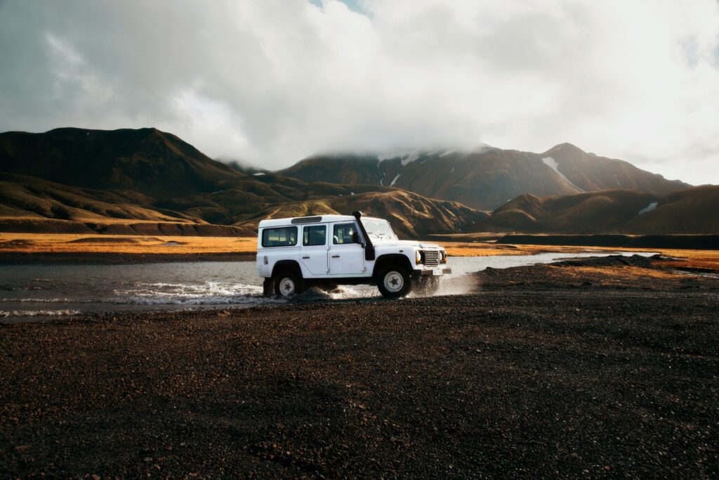 Land Rover Defender crosses an unbridged river in the Icelandic Highlands